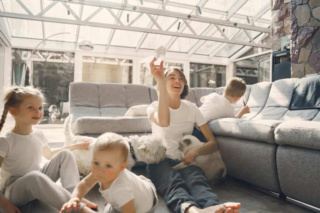 In their new living room: a mother with her young children and pet dogs.