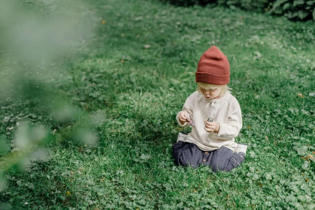 A child on the lawn in a park