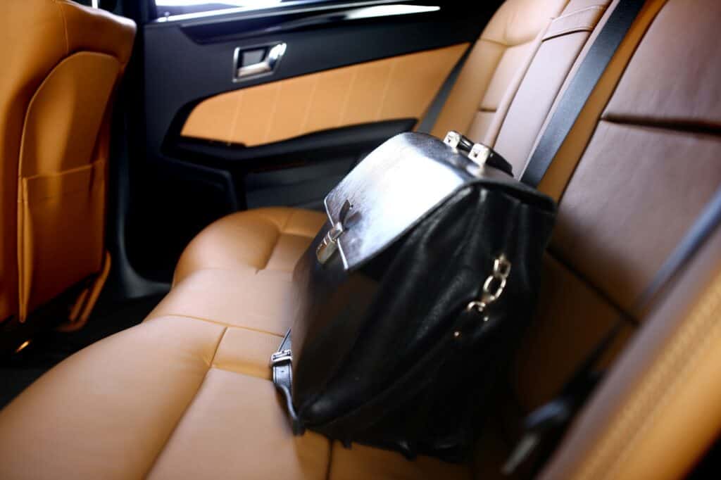 A leather briefcase containing valuable documents inside a personal car