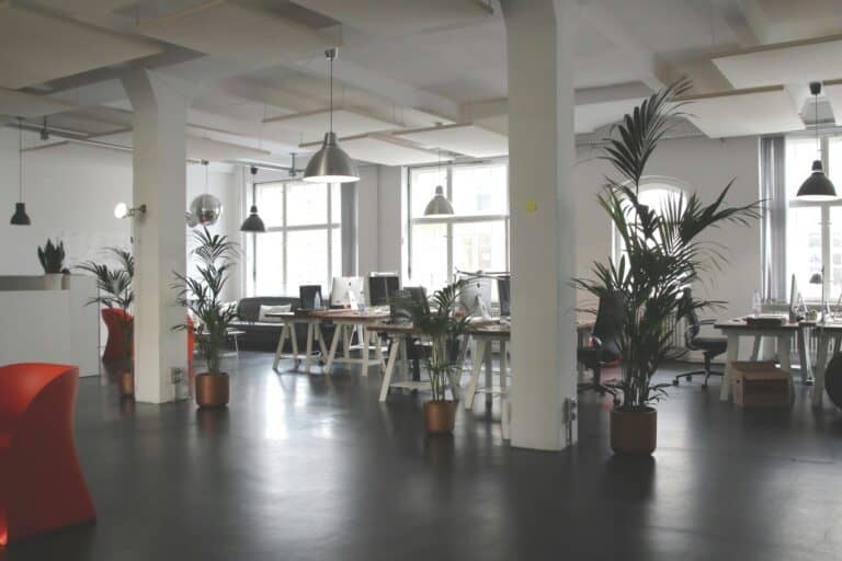 Spacious modern office equipped with tables and chairs and desktops in the concept of 'How to Pack Office Equipment and Furniture'.